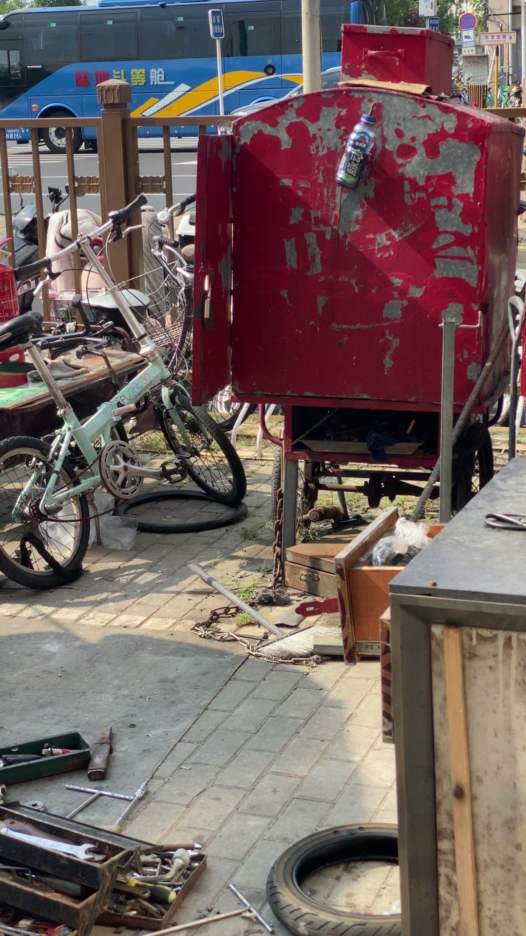 An older Beijing street with bicycles and a cart