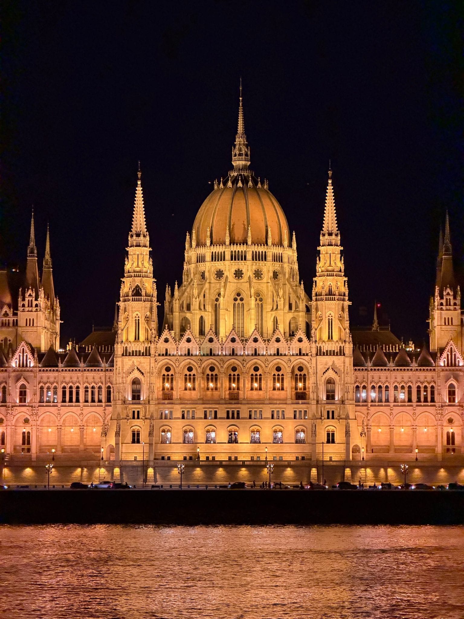 The Hungarian Parliament lit up at night, reflected in the Danube