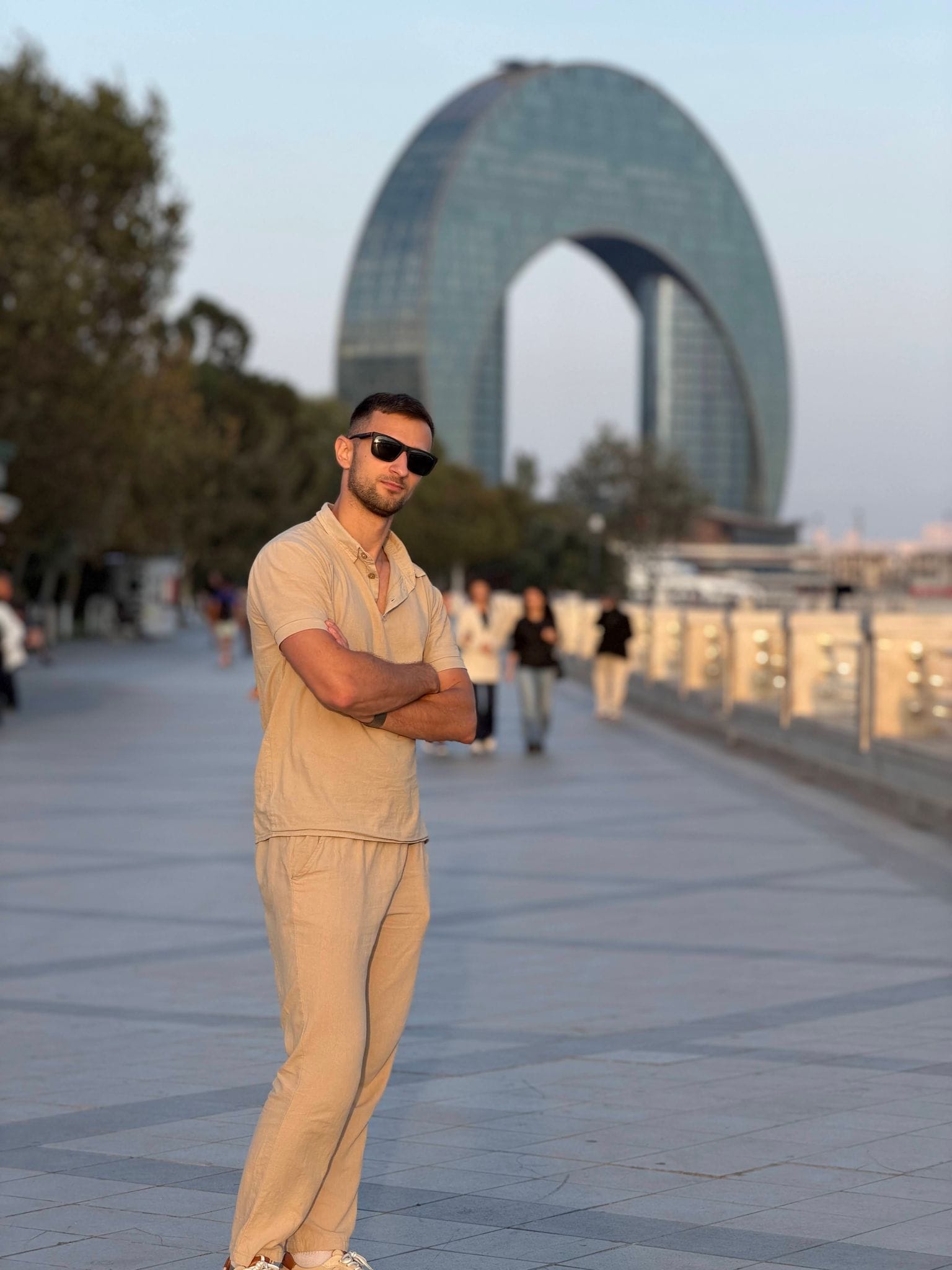 Nikita on the Seaside Boulevard with the ring-shaped Crescent building behind him