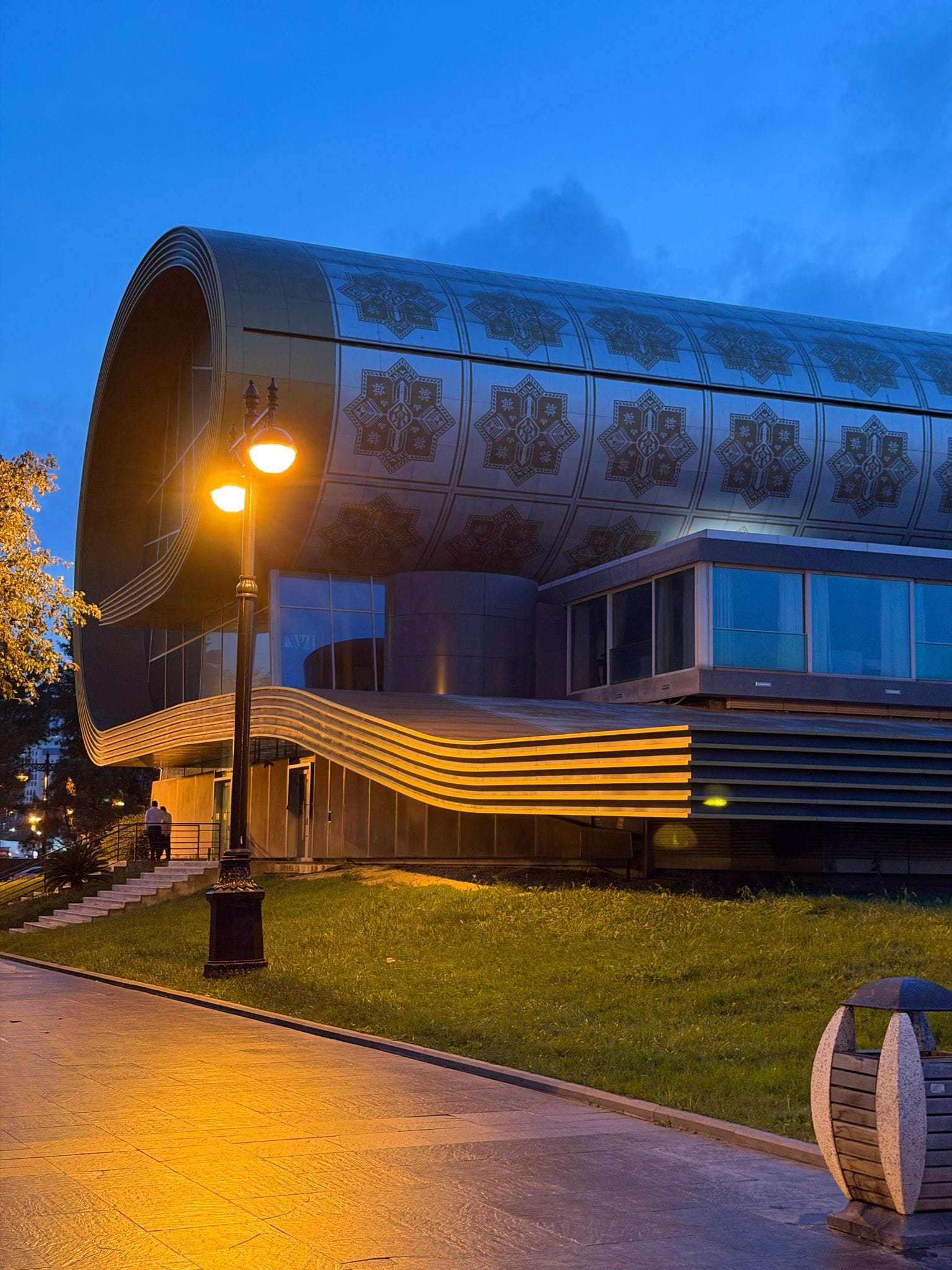 The Azerbaijan Carpet Museum, a building shaped like a rolled-up carpet, at blue hour