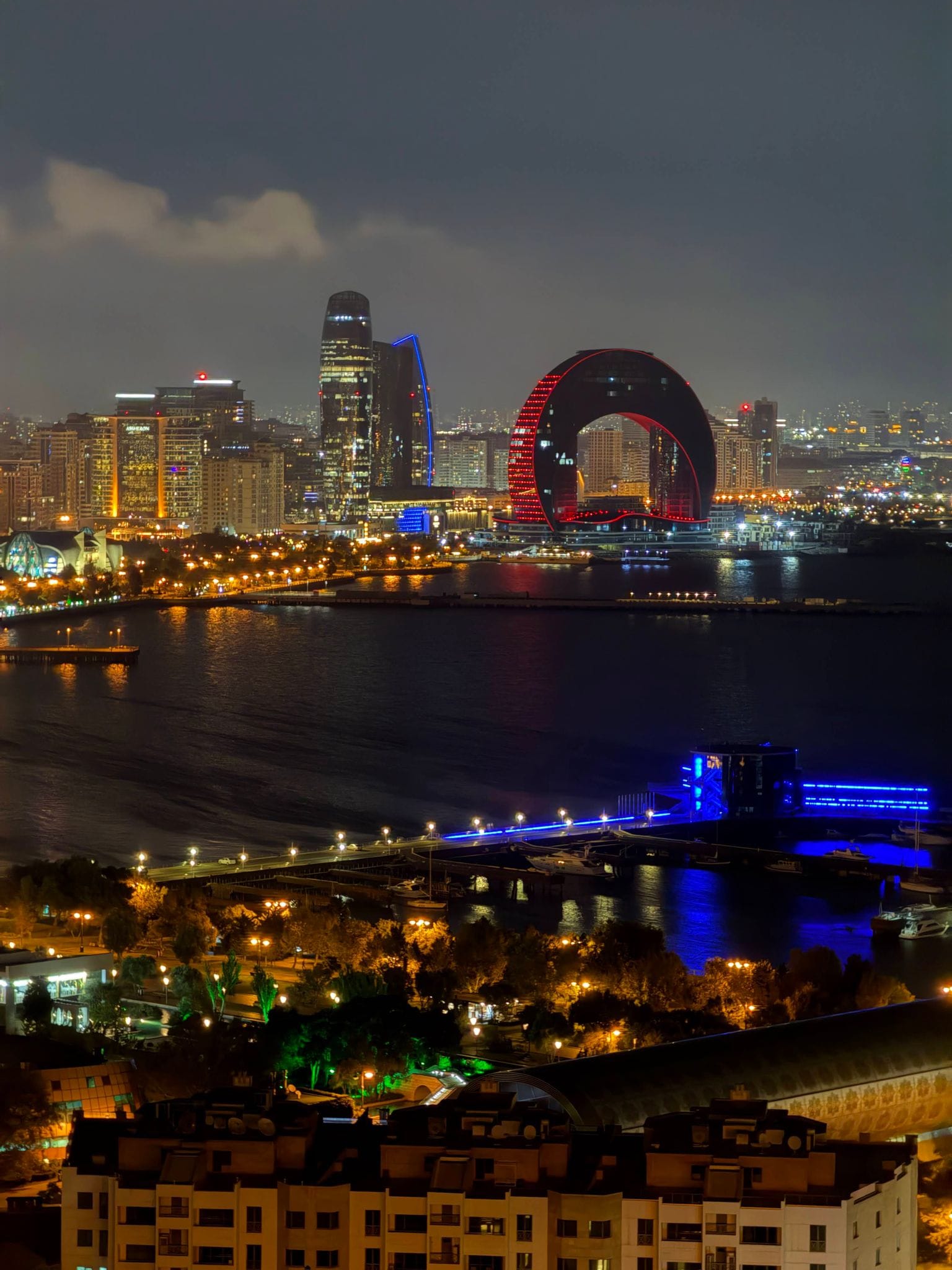 Night view from Highland Park over the Baku bay, with the lit Crescent building and the waterfront