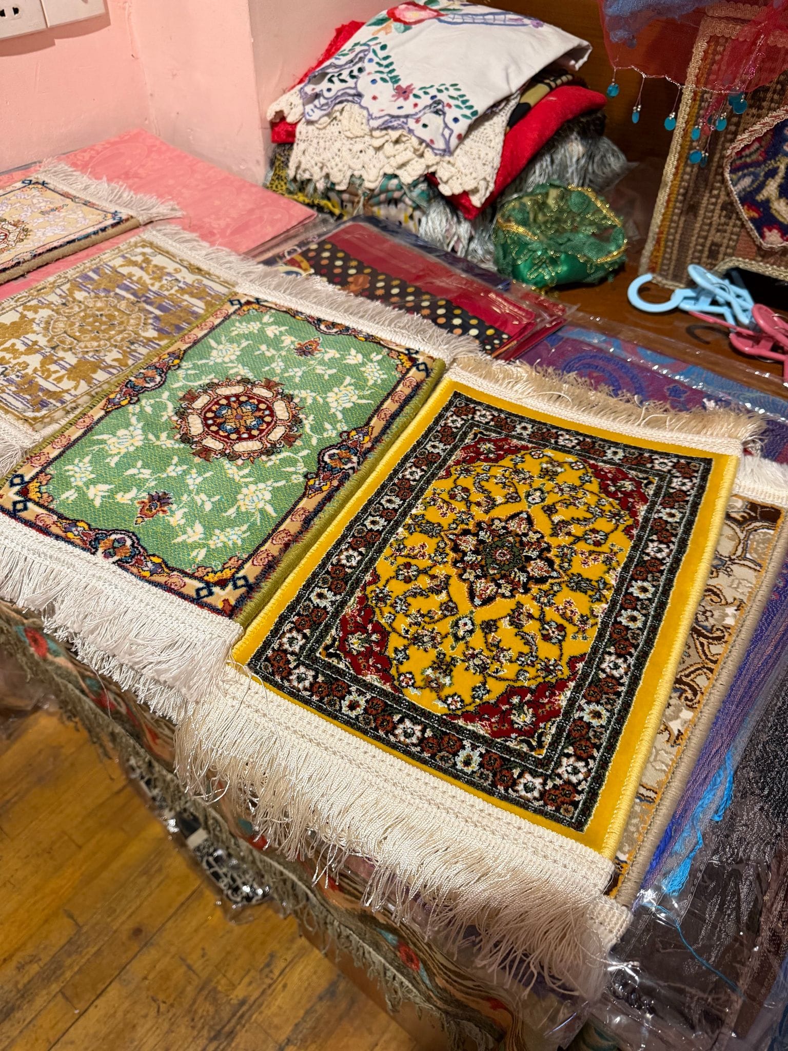Small Azerbaijani carpets with fringes laid out in an Old City souvenir shop